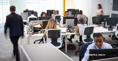Employees working in a busy open concept office