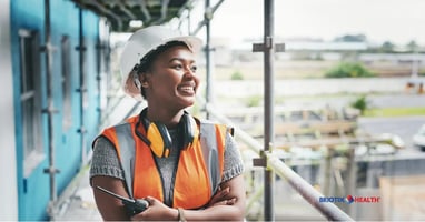 Construction supervisor looks out over construction site